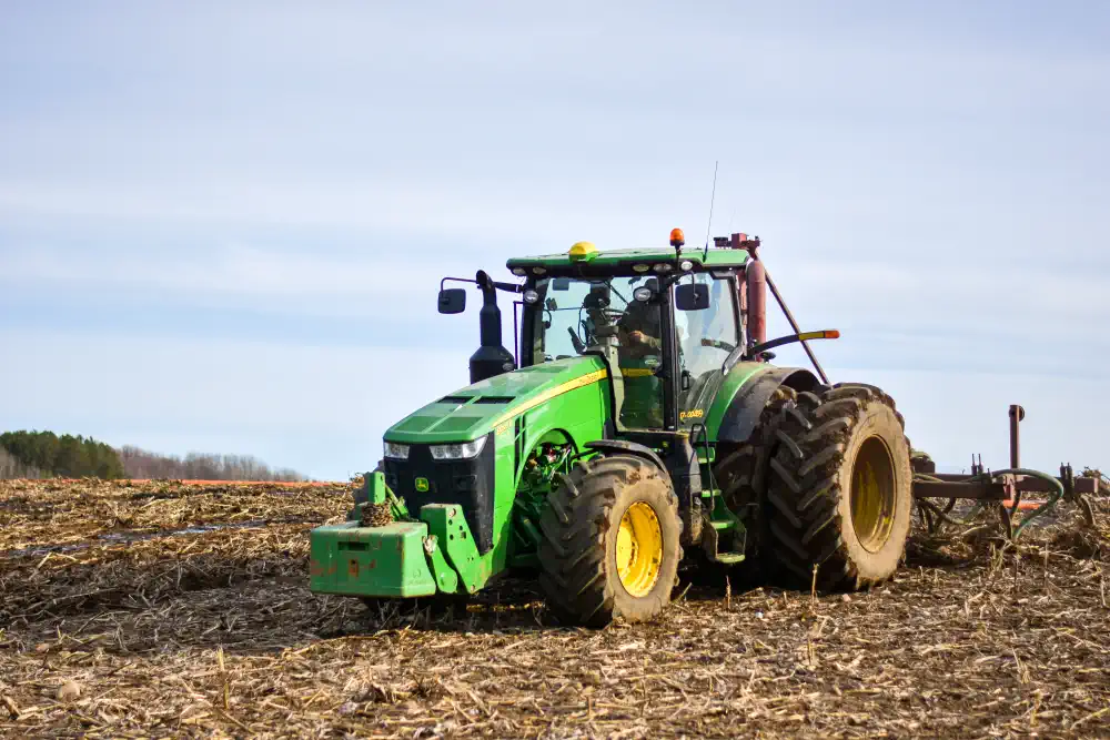Tractor injecting material on corn stubble field